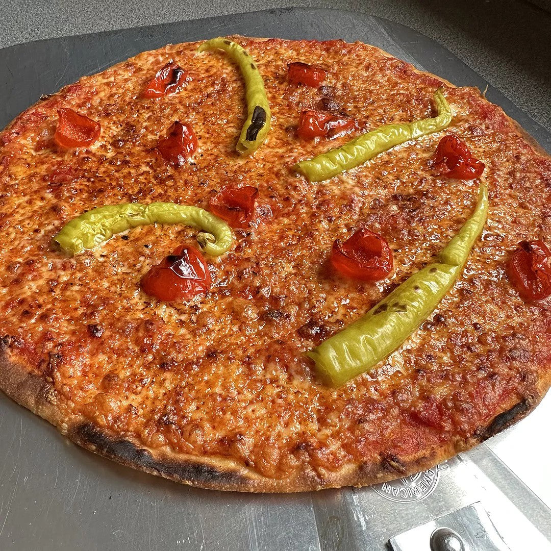 Donostia Foods Guindilla Peppers slightly charred on a fresh baked pizza.