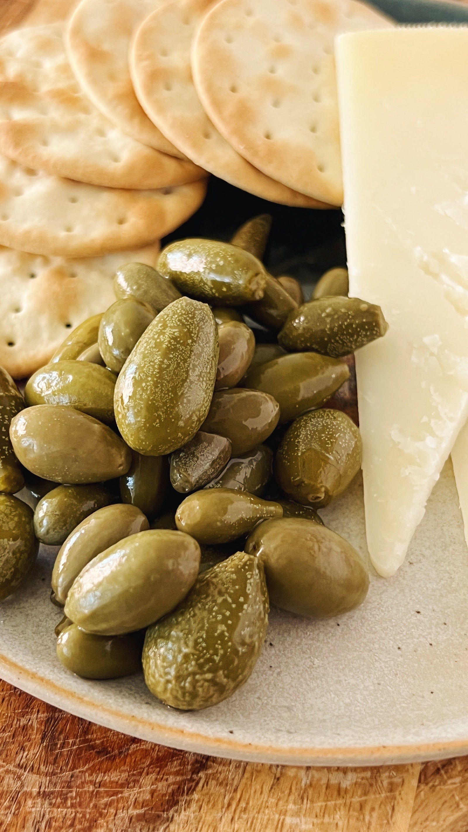 Donostia Foods Tears of Caperberries with a mild cheese and water crackers on a handmade pintxo plate