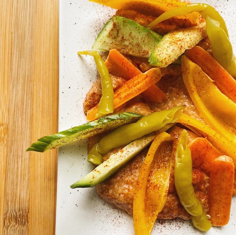 Escalivada dip on a plate with guindilla peppers and cucumbers and paprika - Donostia Foods