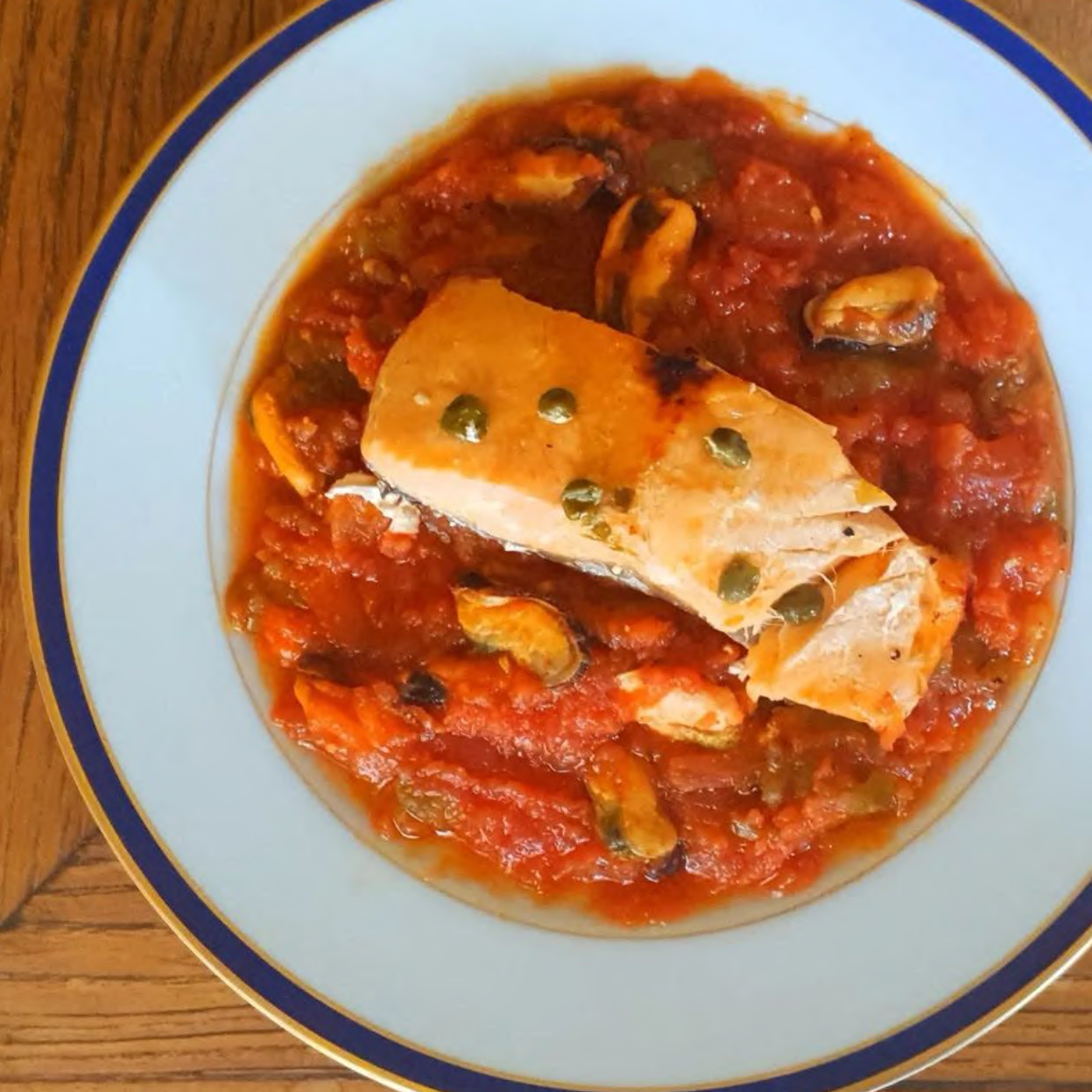 Salmon in Parchment Over Fire-Roasted Tomato and Pimiento Salad - Donostia Foods