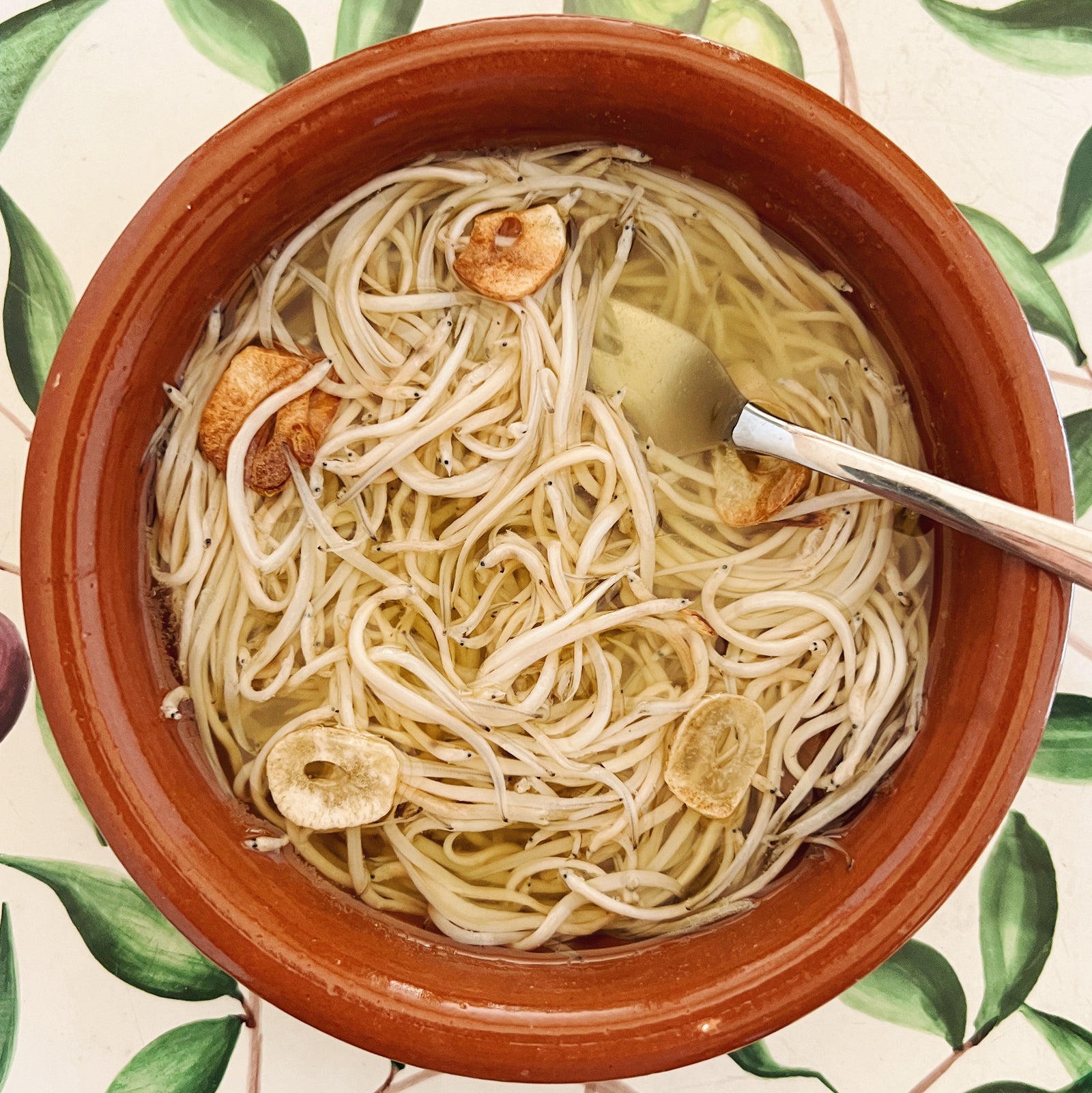 Traditional Angulas with garlic in olive oil in a serving dish - Donostia Foods