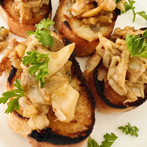 Donostia Foods Clams in Brine and Nam Prik Pao Chili Jam on little toasts.