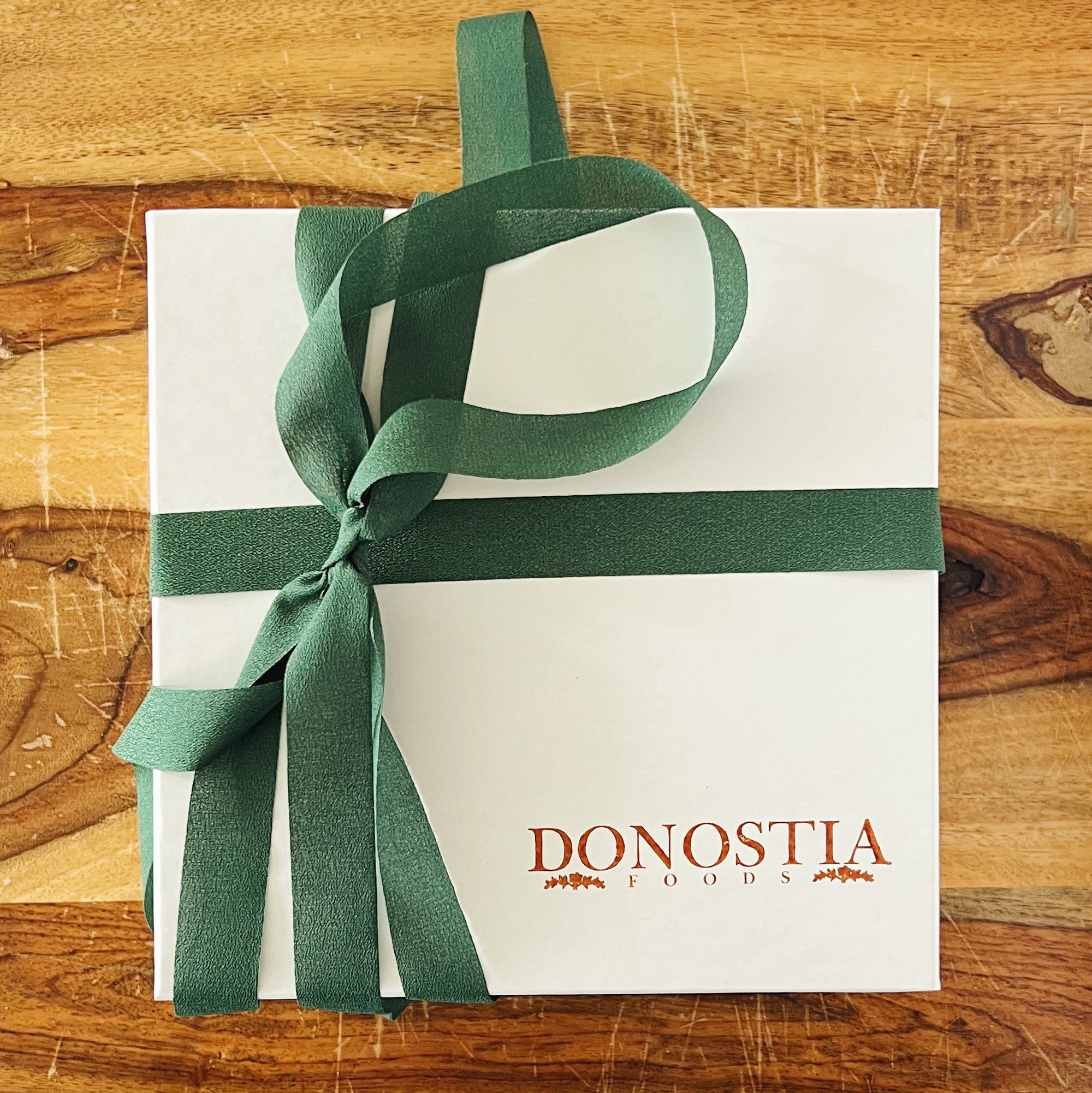 Donostia Tinned Fish Dish wrapped in white box with Donostia logo and green ribbon.