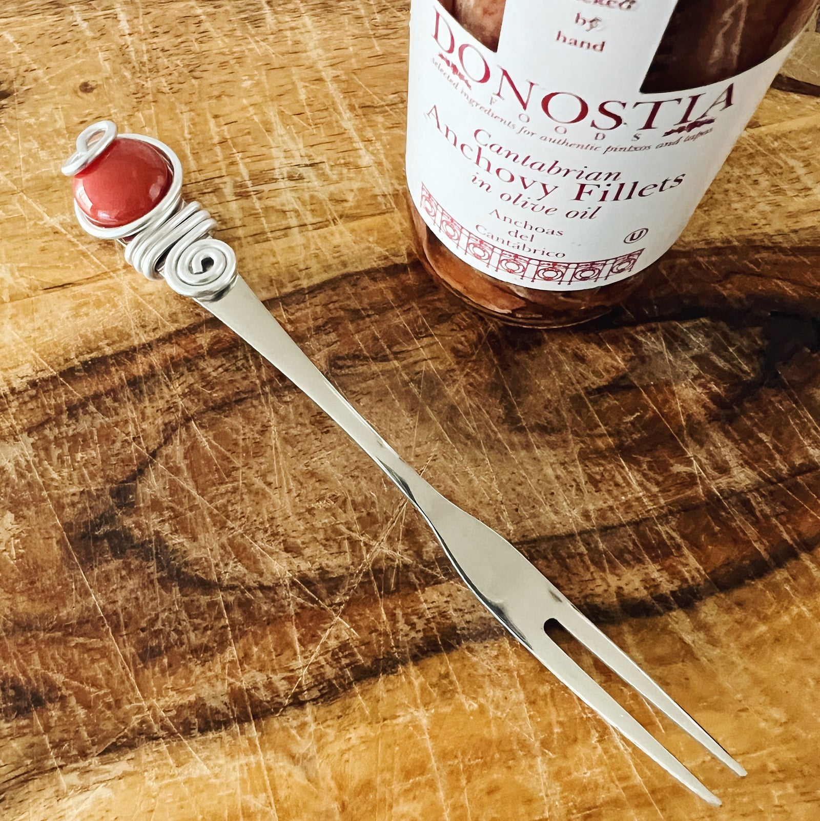 Little Anchovy Appetizer Fork with wrapped wire handle and red marble holding end.