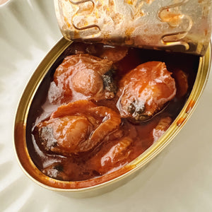 An open tin of scallops in vieira sauce